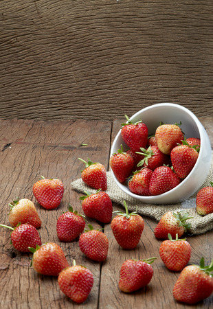 Fresh strawberries on old wooden backgroundの写真素材