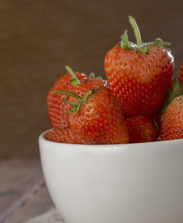 Fresh strawberries on old wooden backgroundの写真素材