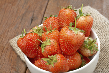 Fresh strawberries on old wooden backgroundの写真素材