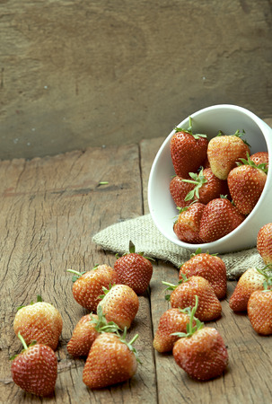 Fresh strawberries on old wooden backgroundの写真素材