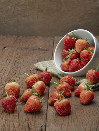 Fresh strawberries on old wooden backgroundの写真素材