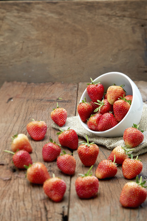 Fresh strawberries on old wooden backgroundの写真素材