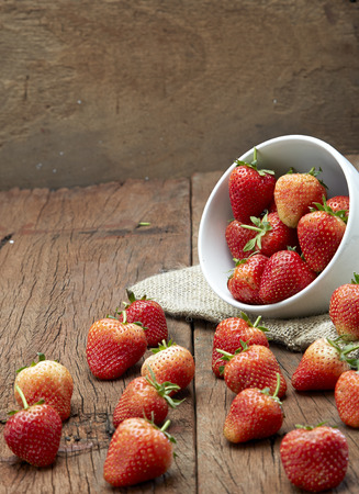 Fresh strawberries on old wooden backgroundの写真素材