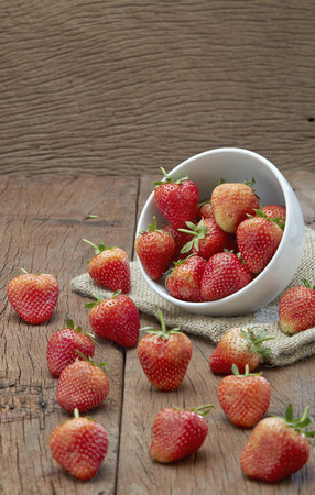 Fresh strawberries on old wooden backgroundの写真素材