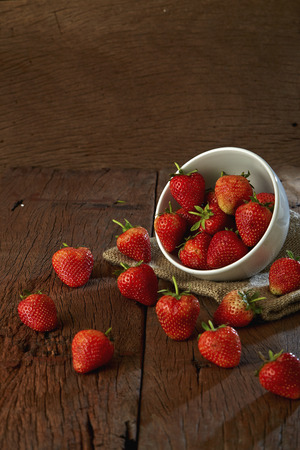 Fresh strawberries on old wooden backgroundの写真素材