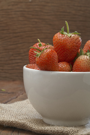 Fresh strawberries on old wooden backgroundの写真素材