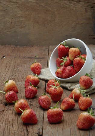 Fresh strawberries on old wooden backgroundの写真素材