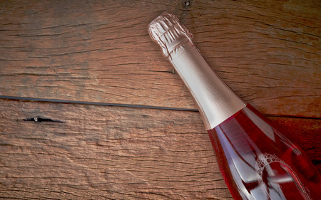 bottle flavoured fruit wine on woodの写真素材