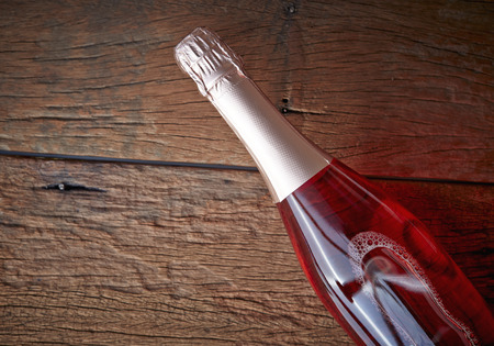 bottle flavoured fruit wine on woodの写真素材