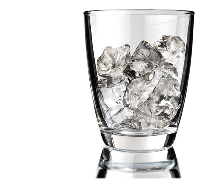 Glass of scotch whiskey and ice on a white backgroundの写真素材