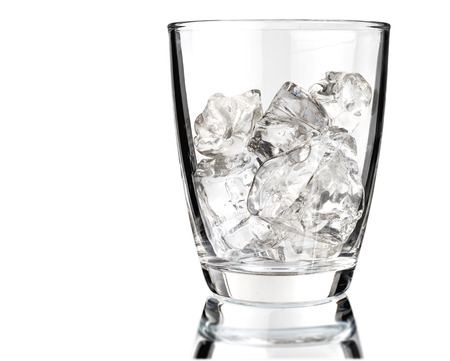 Glass of scotch whiskey and ice on a white backgroundの写真素材