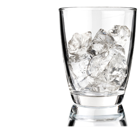 Glass of scotch whiskey and ice on a white backgroundの写真素材