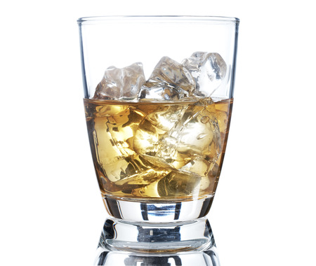 Glass of scotch whiskey and ice on a white backgroundの写真素材