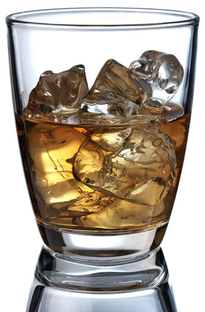 Glass of scotch whiskey and ice on a white backgroundの写真素材