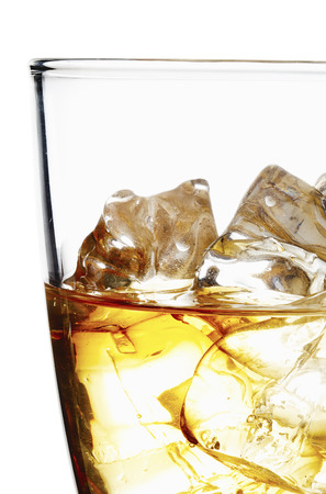 Glass of scotch whiskey and ice on a white backgroundの写真素材