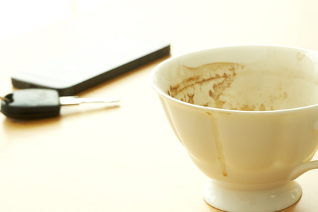 coffee cup And Telephone With Car Key On The wood Tableの写真素材