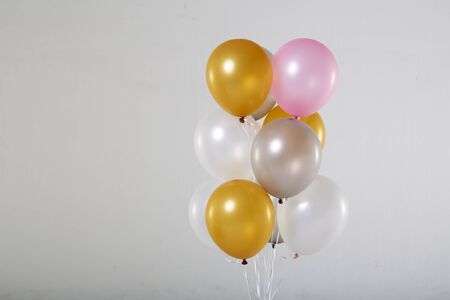 Colorful balloons on a gray background.