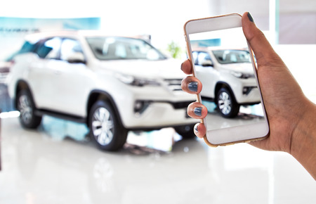 using smartphone, car salesの写真素材