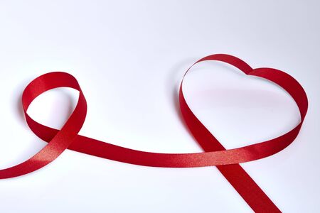 Red heart ribbon, on white backgroundの写真素材