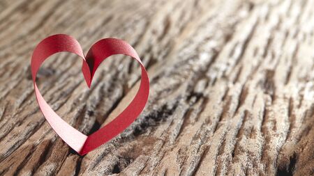 Red ribbon hearts on wooden background, Valentines day conceptの写真素材