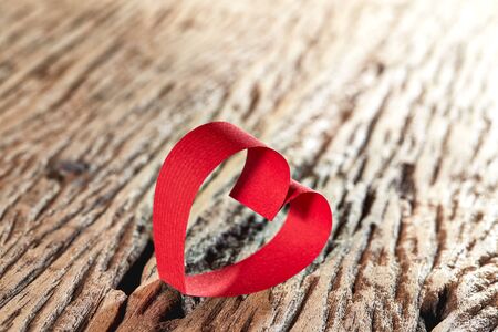 Red ribbon hearts on wooden background, Valentines day conceptの写真素材