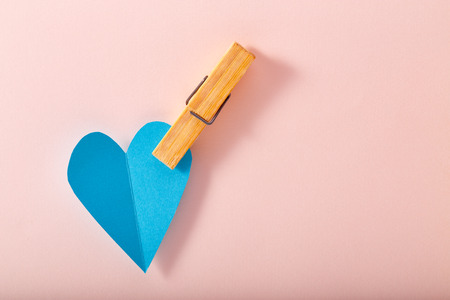 Blue paper heart on pink paper, backgroundの写真素材