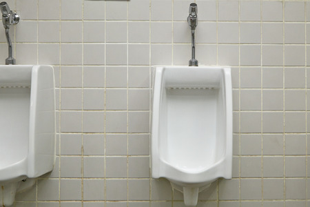 White ceramic urinal in for men in public toilet as modern restroom conceptの写真素材