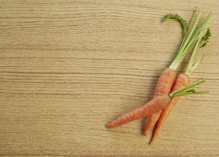 Whole fresh carrots on a wooden background, Vegetableの写真素材