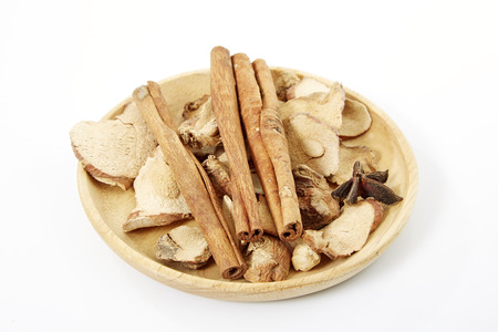 Cinnamon, star anise, cardamom, galangal,  on a white background.