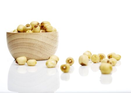 lotus seeds in a bowl on a white table.の写真素材