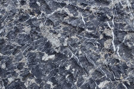 Black marble pattern on a surface that looks natural
