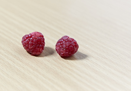 Fresh raspberry on wooden table.