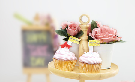 Pink cupcakes on wooden cupcake standの写真素材