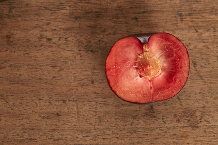 red plum fruit on wooden backgroundの写真素材