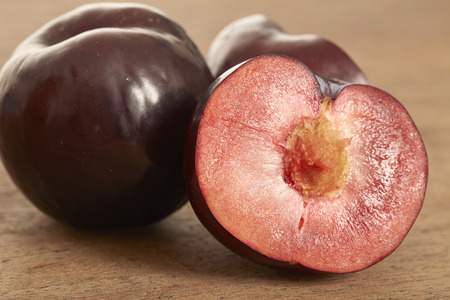 red plum fruit on wooden backgroundの写真素材