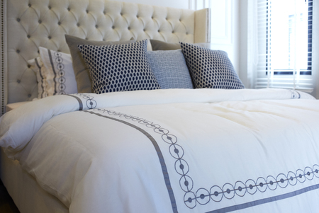 black and white pillows on bed in modern bedroom designの写真素材