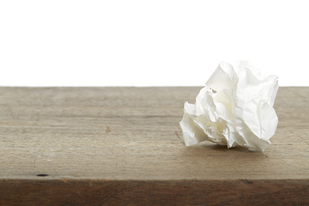 White Crumple paper ball on old wood deskの写真素材