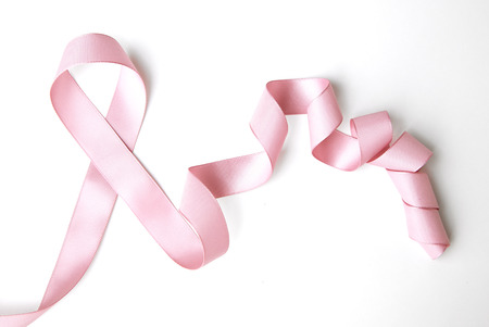 pink ribbon border with curls isolated on whiteの写真素材