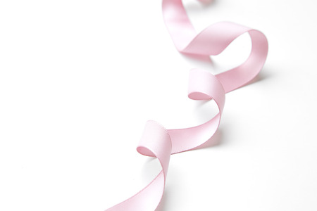 pink ribbon border with curls isolated on whiteの写真素材