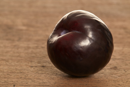 Sweet plum on wooden backgroundの写真素材