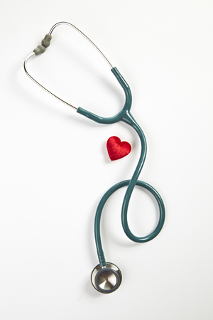 Red heart and stethoscope isolated on white backgroundの写真素材