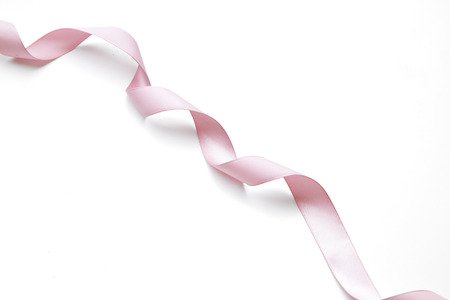 pink ribbon border with curls isolated on whiteの写真素材