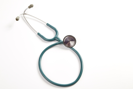 a green stethoscope against medical isolated on Whiteの写真素材