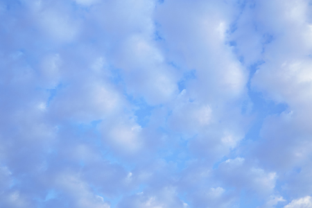 blue sky is covered by white clouds and raincloud, and space for add text above