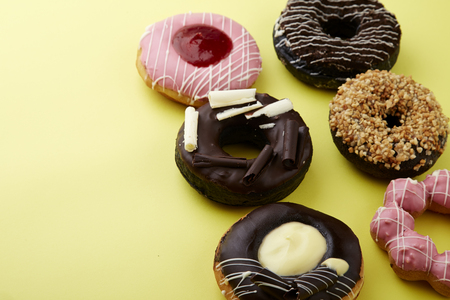 donuts on a yellow background with copy space. Top Viewの写真素材