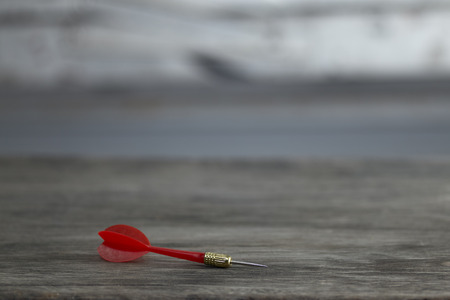 red dart on the brown wooden backgroundの写真素材