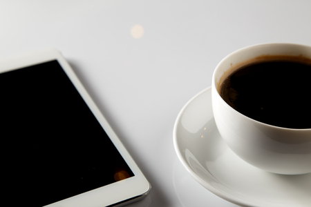 White tablet With coffee cup on White Background for copy space, Concept to Businessの写真素材
