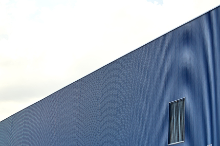 Metal sheet wall panels and roofs against clear blue skyの写真素材