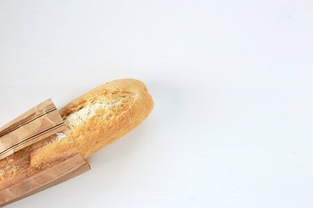 French bread baguette on a table white background. Top view with space for your textの写真素材