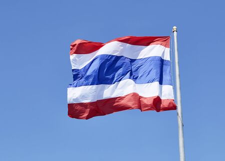 State national flag of Thailand waving on blue sky background.の写真素材